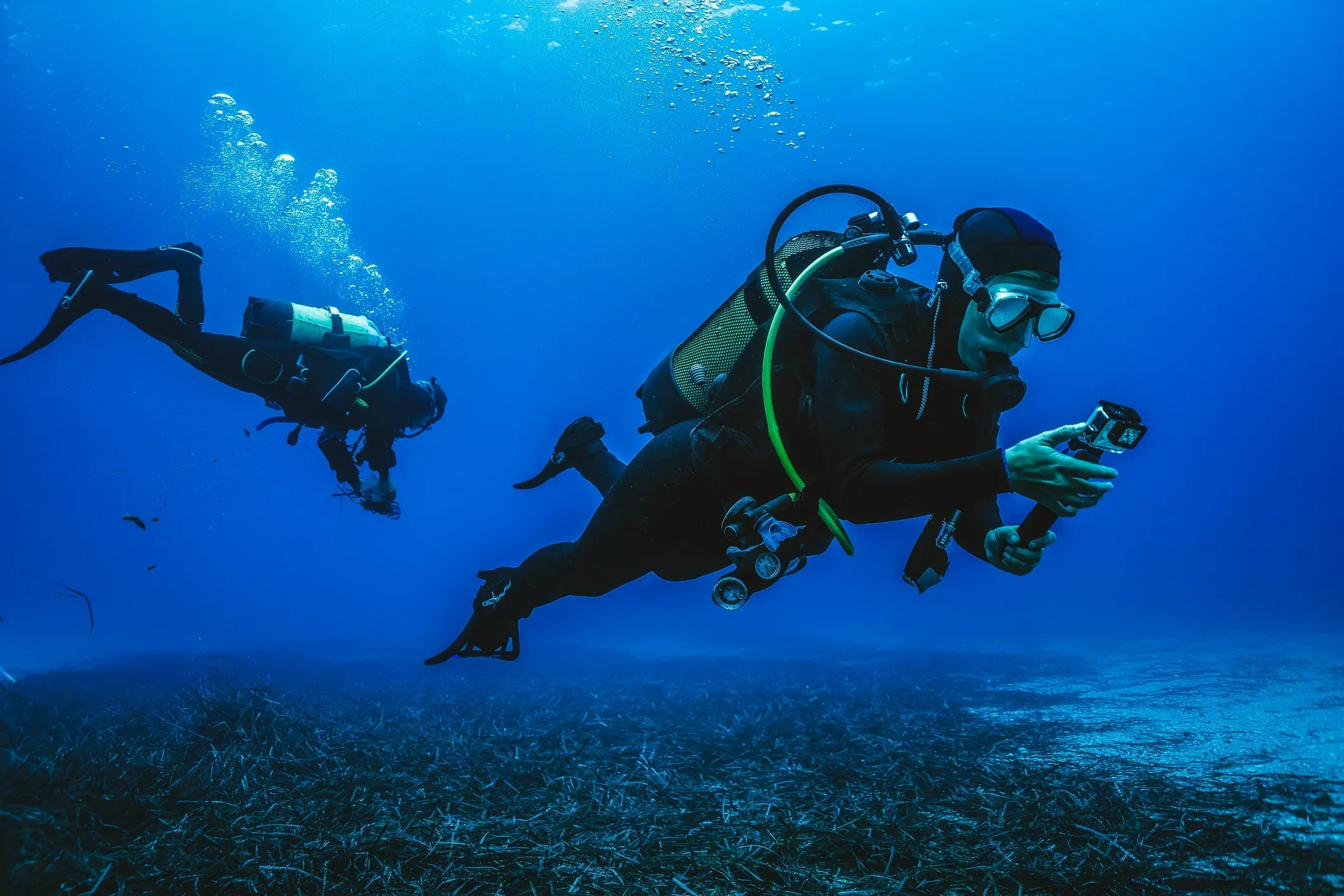 PADI scuba diving instructor teaching a student underwater